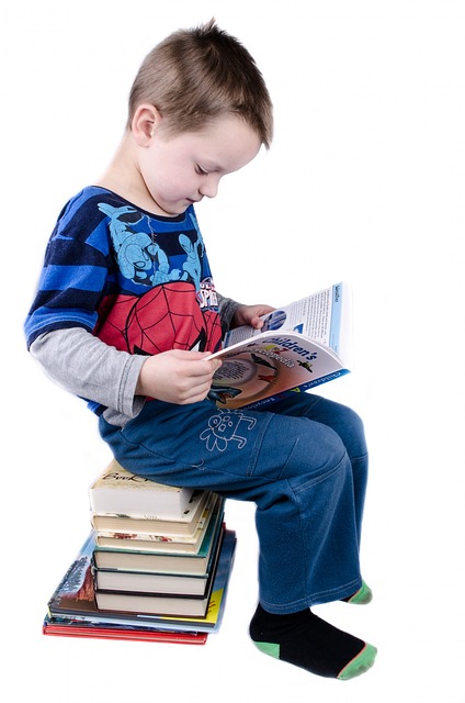 child development. image of young boy reading book