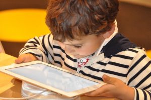child reading from iPad